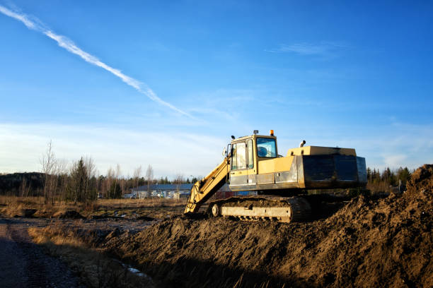 istock Yellow excavator on a road construction site 1371392007
