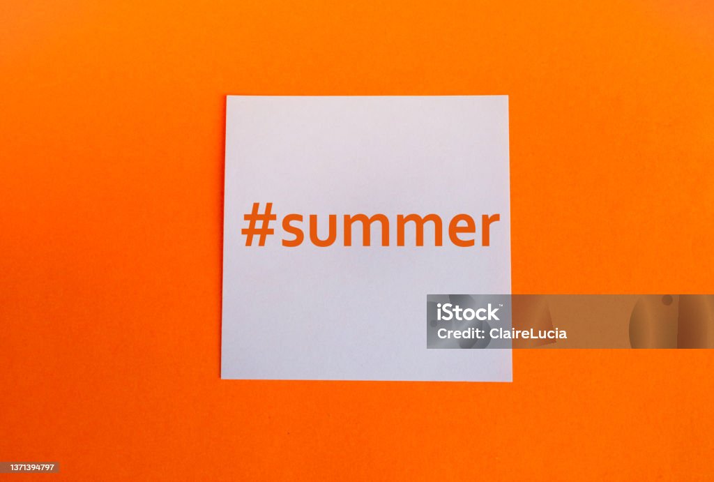 White paper square on an orange background with the hashtag summer in English , concise style White paper square on an orange background with the hashtag summer in English , concise style. Hashtag Stock Photo