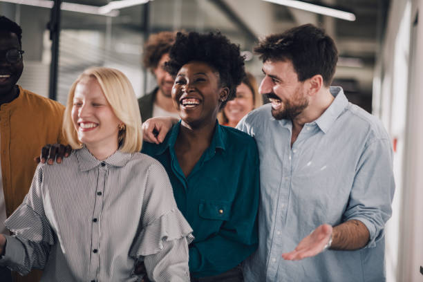 istock Cheerful young people walking together in shared office hallway 1371402330