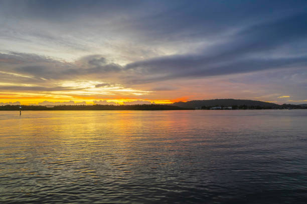 istock Sunrise waterscape with a mix of low, medium and high clouds 1371409493