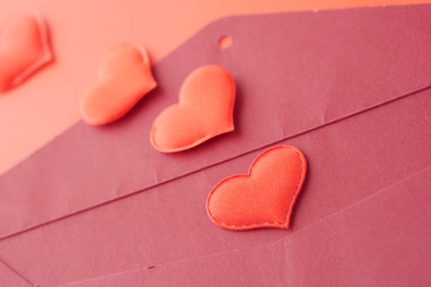 istock heart shape symbol and envelope on red background 1371410863
