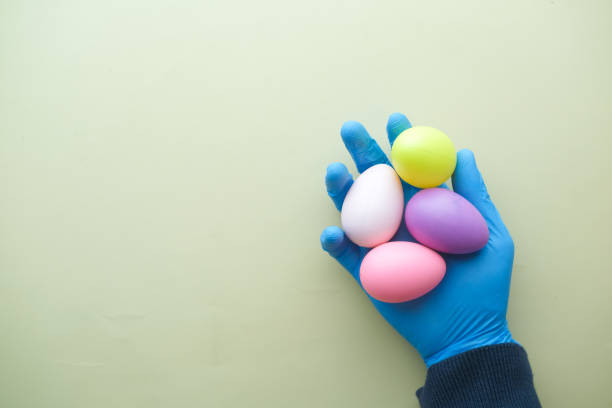 istock hand in latex gloves holding easter eggs 1371412001