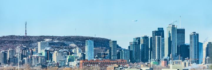 Montreal city skyline panorama of Quebec travel destination in Canada. Winter scenery background of mount royal mountain and skyscrapers buildings downtown.