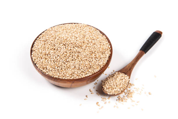istock Wooden bowl with sesame seeds isolated on white background 1371423551