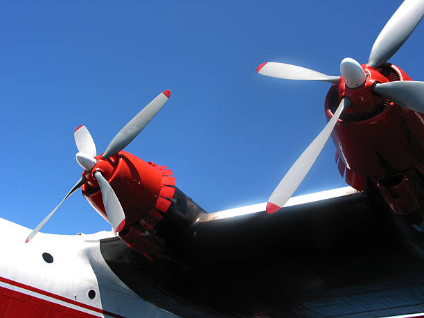 Twin Propellers Two, red-tipped propellers of a Martin Mars Water Bomber airplane used for fighting forest fires. Taken at Sproat Lake, Port Alberni, British Columbia. military tanker airplane photos stock pictures, royalty-free photos & images