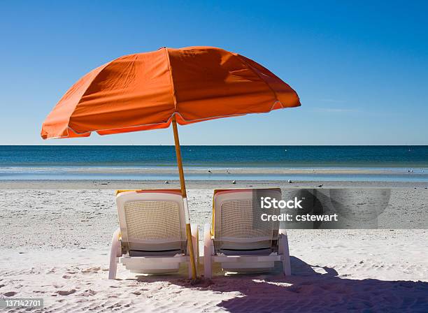 A Setting On The Beach Of Beach Chairs And An Umbrella Stock Photo - Download Image Now