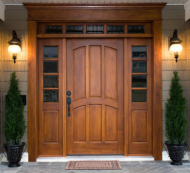 Beautiful Wooden Door A beautiful wooden door graces the entrance to a west coast contemporary home. front door photos stock pictures, royalty-free photos & images