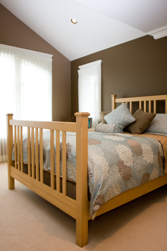 Vaulted ceilings and colorful bedding highlight the master bedroom of a new home.