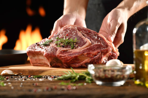 istock Raw steak meat beef on chopping board with flaming background 1371431458