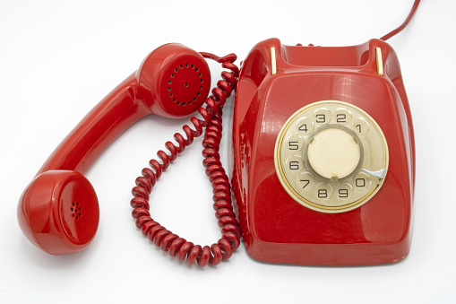 Old red telephone, isolated on a white background