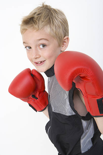 istock Young boy wearing red boxing gloves 137143338