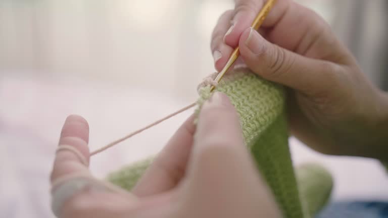 View of knitting with cream yarn.