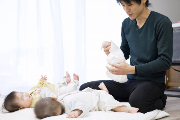istock Asian dad changing baby clothes 1371445206