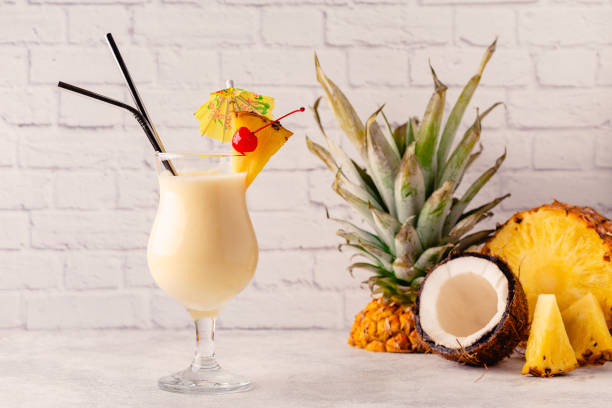 Traditional caribbean cocktail pina colada in a glass, garnished with a slice of pineapple. stock photo