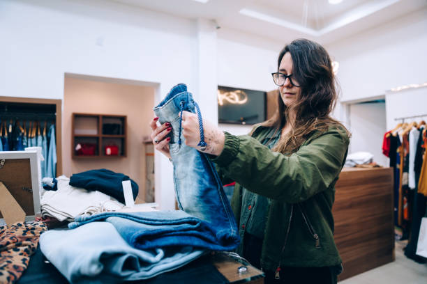 istock Female customer buying jeans 1371445610