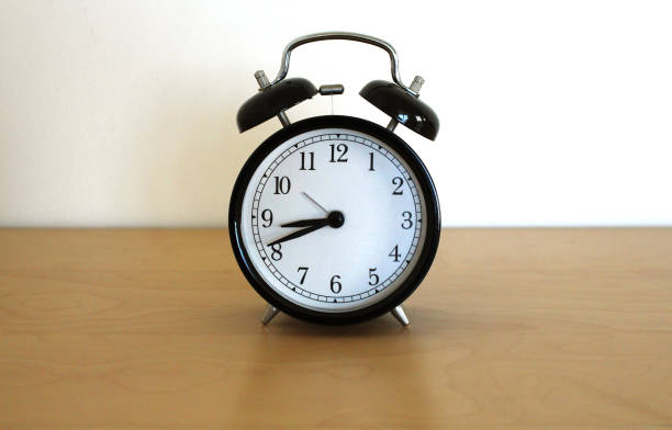 istock retro alarm clock is on the bedside table 1371446914