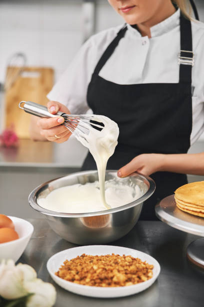 istock confectioner wearing black uniform while working in confectionery. 1371447739