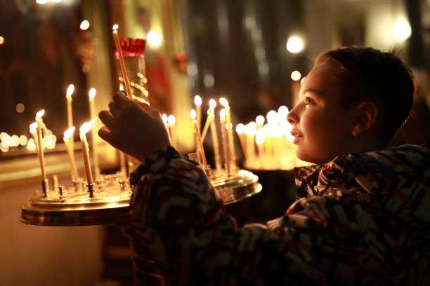 istock Kid with candle in russian orthodox church 1371449054