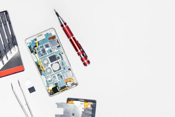 istock broken mobile phone with tools on the desk. top view with copy space. 1371455989