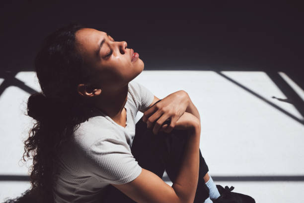 scatto di una giovane donna seduta in un manicomio - suicidio foto e immagini stock