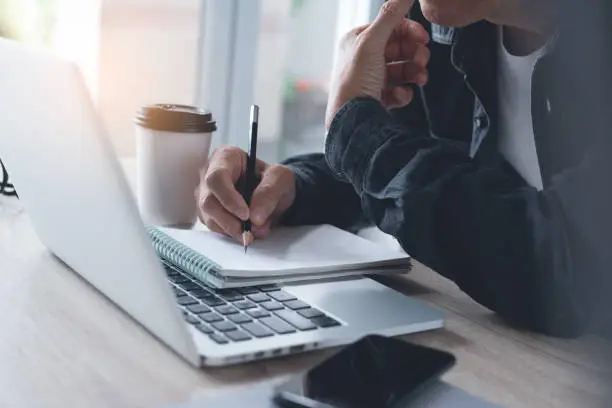 Photo of Businessman working on laptop computer from home