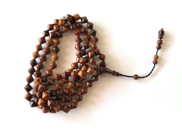 istock 99 Islamic prayer beads on a white background for ramadan, eid adha, eid fitr, flyer islamic and etc . close up of wood tasbih 1371460626