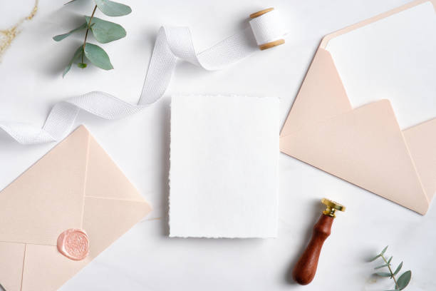 istock Elegant wedding invitation card template and pastel pink envelopes on marble table. Aesthetic wedding stationery set. 1371464357