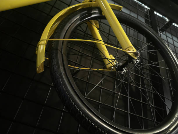 istock A bicycle hung on the wall in yellow with black wheels 1371466179