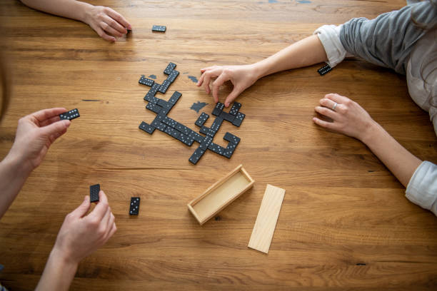 istock Women playing dominoes at Home 1371469335