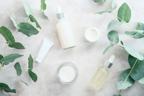 istock Transparent cosmetic packaging with eucalyptus leaves on stone table. SPA natural organic beauty products, branding. 1371470584