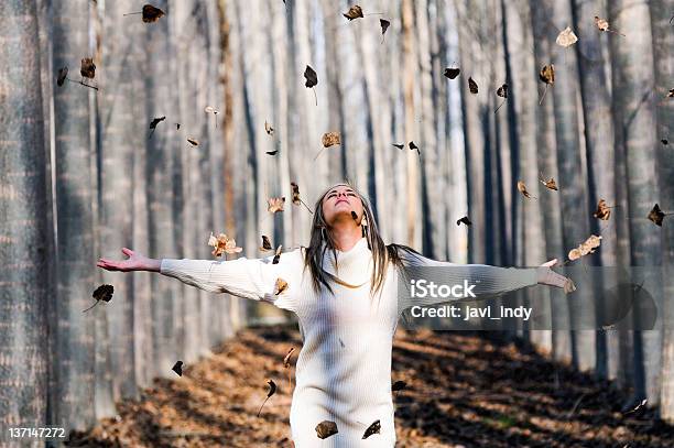 Beautiful Blonde Girl With Falling Leaves In The Autumn Wood Stock Photo - Download Image Now