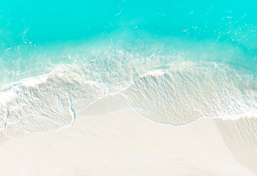 Top view of turquoise color of  wave water background on the summer beach at the seashore and  white  sand beach -Summer pattern image