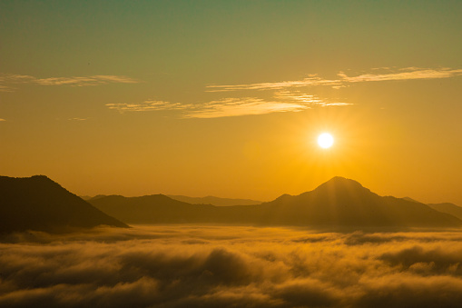 Sea Fog and Golden sunrise covers the area on the top of hill Doi Phu Thok, Chiang Khan, Loei, Thailand with background of sunrise on winter.