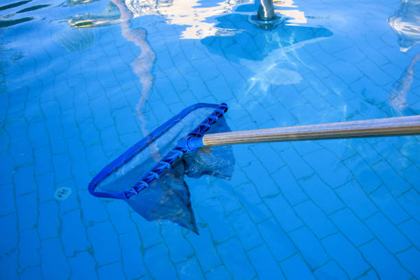 istock Cleaning pool from garbage with special net. Clear water with blue tint. Reflections in water. Concept of hygiene and healthy lifestyle. Horizontal photo. Copy space. Close-up. Selective focus. 1371476367