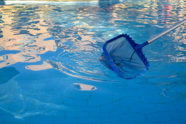 istock Cleaning pool from garbage with special net. Clear water with blue tint. Reflections in water. Concept of hygiene and healthy lifestyle. Horizontal photo. Copy space. Close-up. Selective focus. 1371476372