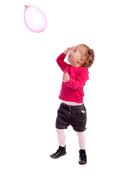 istock little girl playing with a balloon 137147763