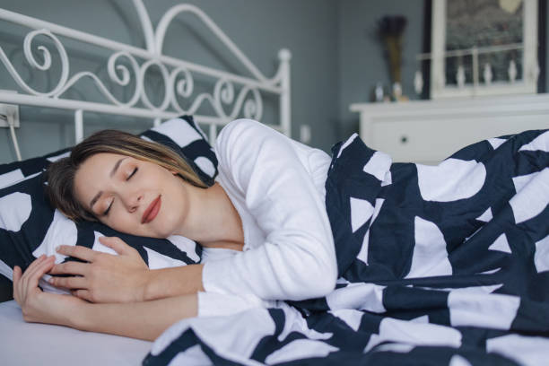 istock Young woman sleeping in bed 1371481927