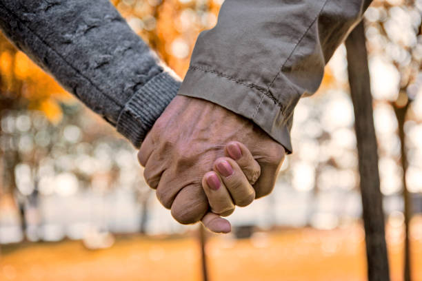 istock Senior couple walking in public park 1371482091