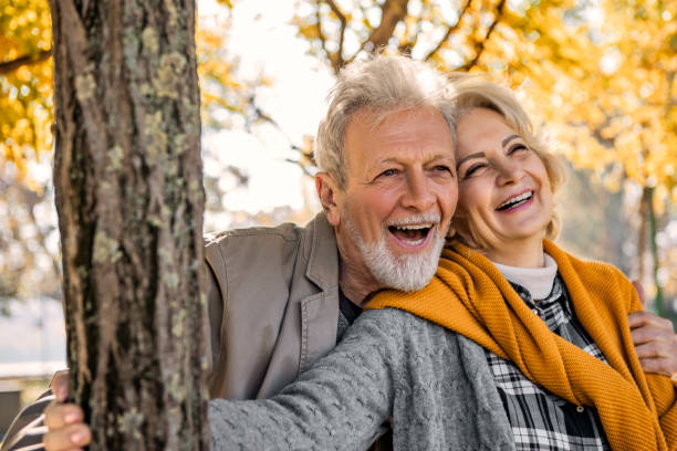 istock Senior couple in park laughing 1371482198