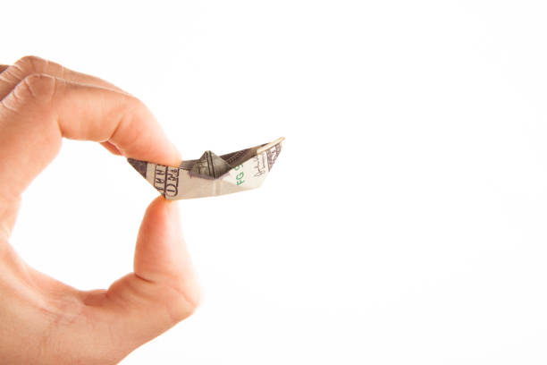 image of origami money ship hand white background