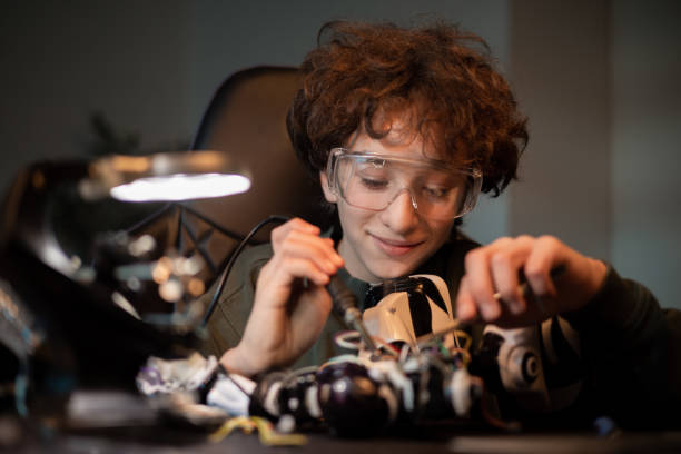 istock A young boy is busy soldering a robot. A child learns electronics, repairs a toy and assembles a remote control system 1371486741