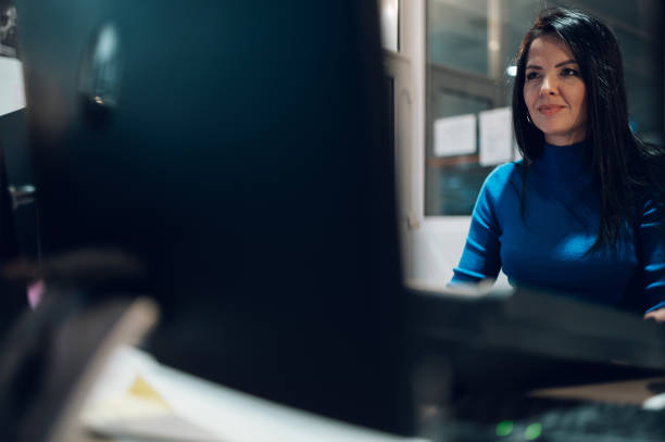 istock Middle aged woman using equipment in control room on a tv station 1371487021
