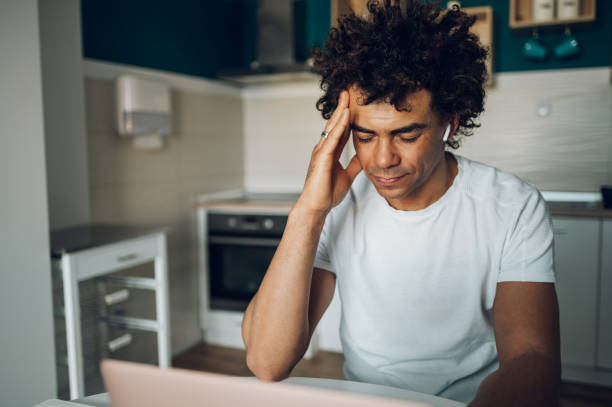 istock Tired young african american man feeling stressful while working from home 1371487037
