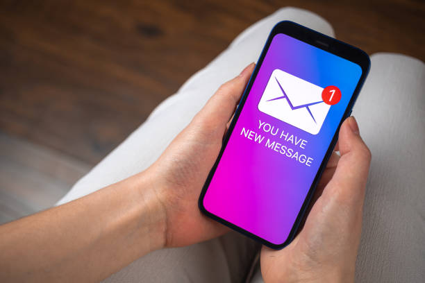 istock Hands holding smartphone with new message concept on screen. New e-mail notification business background photo 1371491972