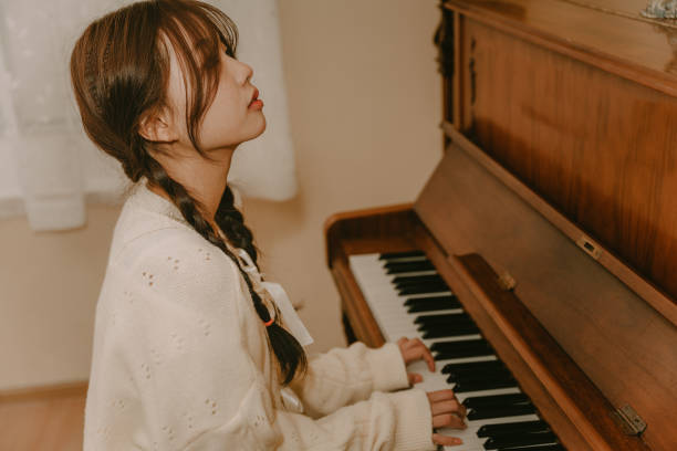 istock A girl playing the piano 1371492745