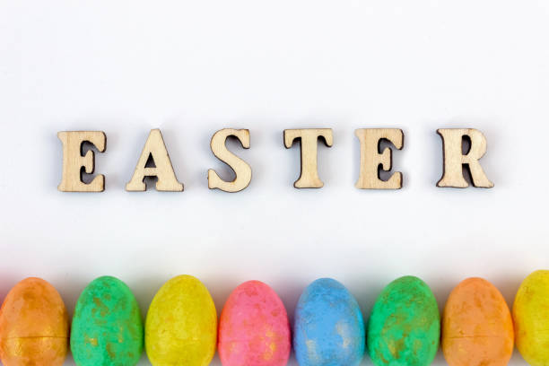 The inscription Easter on a white background with colorful eggs.