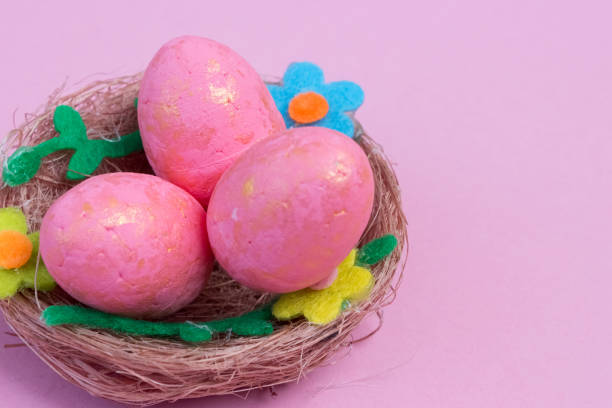 istock Pink Easter eggs in a nest on a pink background 1371495848