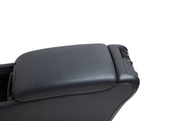 istock Plastic element of car interior is covered in black leather - armrest or a glove compartment - spare part with air conditioning holes on a white background. Catalog for site 1371497221