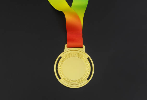 istock Gold medal with rainbow ribbon on black 1371497741