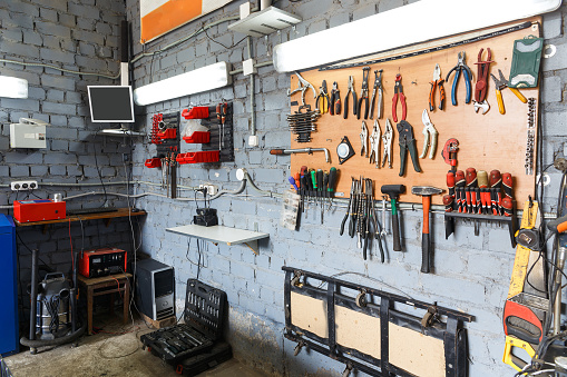 A set of tools in the real auto repair shop. The organization of the workplace at the mechanic.
